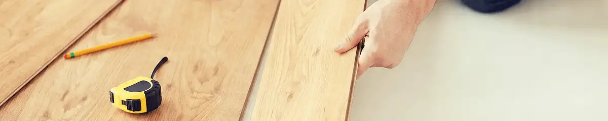 A professional installing wood flooring in Boston, MA