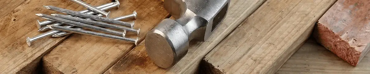 Hammer and nails on hardwood flooring boards in Boston, MA