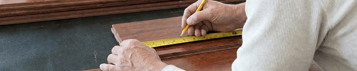 A professional installing wood flooring in Boston, MA